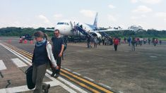 people walking towards an airplane on the tarmac