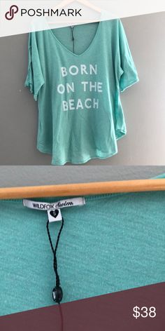 WILDFOX new born on the beach tee WILDFOX new born on the beach tee never worn. Turquoise color Wildfox Tops Blue Tops For Loungewear During Beach Season, Light Blue Relaxed Fit Tops For Beach Season, Light Blue Summer Vacation T-shirt, Turquoise Beach Tops, Turquoise Cotton Beach Tops, Casual Blue Top For Vacation, Beachy Blue Tops For Spring, Casual Turquoise Top For Spring, Trendy Vacation Tops For Day Out