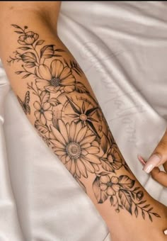 a woman with a flower tattoo on her arm