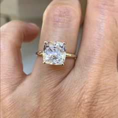 a woman's hand with a yellow and white diamond ring