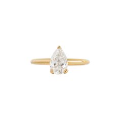 a yellow gold ring with a pear shaped diamond