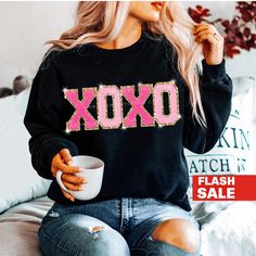 "This beautiful XOXO sweatshirt is the coziest necessity for your winter wardrobe! The perfect Valentine's Day gift for women! This is our favorite crewneck to wear while running errands or to cozy up in at home! *UNISEX SIZING - Tees and Sweatshirts are unisex, relaxed/loose fit *Ships fast from Delaware, USA *Shop with Confidence! We are a 5-Star Rated Shop operating since 2015! SHIPPING: We have the fastest handmade Production time! Most items ship within 1-3 days (see each listing's \"Estima Holiday Tee Shirts, Valentines Sweatshirt, Heart Sweaters, Gold Glitter Heart, Valentines Day Sweatshirt, Sweatshirt Details, Sweatshirts For Women, Heart Sweatshirt, Valentine T Shirts