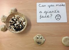 a table topped with cookies next to a sign that says can you make a giant face?