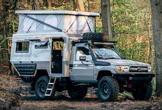 an off road vehicle parked in the woods