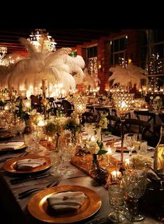 a table is set with candles, plates and place settings for an elegant dinner party