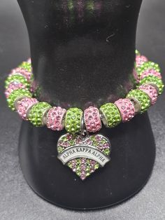 SORORITY JEWELRY-Delta pink and green with AKA heart charm bracelet The bracelet size 7.87 inches silver snake chain charm bracelet Diameter 3mm Item weight without beads 9.3 ounces Pink Beaded Charms Bracelets For Valentine's Day, Pink Beaded Bracelets With Charms For Valentine's Day, Green Heart-shaped Charms Jewelry, Valentine's Day Pink Beaded Bracelets With Charms, Pink Bangle Bracelets For Valentine's Day, Pink Bangle Bracelet For Valentine's Day, Green Heart Beads Bracelet Jewelry, Pink Heart-shaped Beaded Bracelets With Charms, Green Heart Beads Bracelet