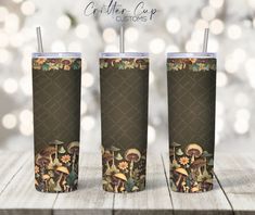 three tumblers with mushrooms and flowers on them