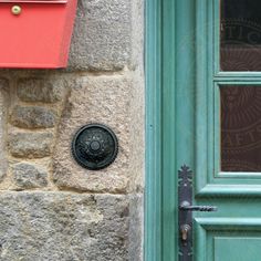 a green door with a red mailbox next to it and a blue front door