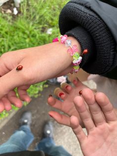 two people holding hands with flowers on them