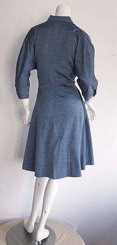 For Sale on 1stDibs - Incredible 1940s B. Altman & Co. Cotton Denim/Chambray dress, with horse buttons up bodice, and at sleeve cuffs! Beautiful lightweight fabric, with a flattering Fitted Collared Denim Dress For Work, Elegant Fitted Denim Dress With Button Closure, Fitted Denim Dress With Button Closure For Work, Classic Fitted Vintage Dress For Workwear, Classic Fitted Cotton Vintage Dress, 1950s Fitted Vintage Dress For Work, Fitted Vintage 1950s Dress For Workwear, 1950s Vintage Dress For Work, 1950s Style Fitted Vintage Dress For Work