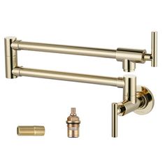 two brass faucets are attached to the side of a wall mounted faucet