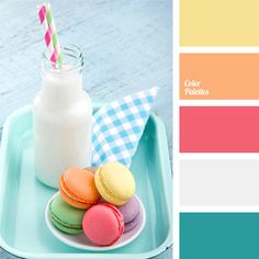 a blue tray topped with macaroons next to a bottle of milk and a glass of milk