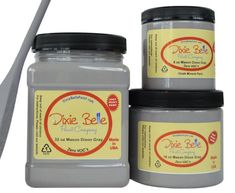 three jars of dixie bee honey sitting on top of each other next to a spoon