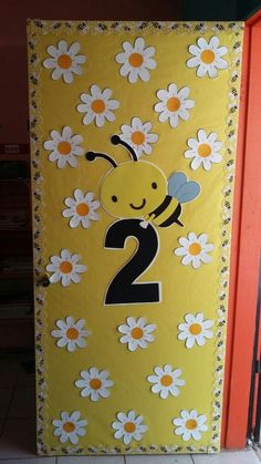 a yellow door decorated with daisies and a number 2