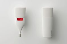 an electronic thermometer is displayed next to a white wall mounted temperature gauge with red letters on it