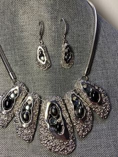 "Silver tone statement necklace and earring set Black cabichons, blue crystals & aurora borealis crystals Brutalist modernist style 18\" chain with 3\" extender Nice substantial chain and lobster clasp Crystal dangle on extension chain Show stopper" Silver Metal Jewelry Sets For Evening, Nickel-free Metal Jewelry Sets For Party, Silver Dangle Jewelry Sets For Evening, Costume Jewelry Sets With Dangle Metal, Costume Jewelry Sets With Metal Dangle, Nickel Free Metal Jewelry For Evening, Nickel-free Metal Jewelry For Evening, Evening Metal Necklaces With Matching Earrings, Evening Jewelry With Lobster Clasp