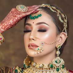 a woman with henna and jewelry on her face