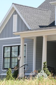 a gray house with white trim and black shutters