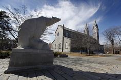 a statue of a polar bear in front of a church