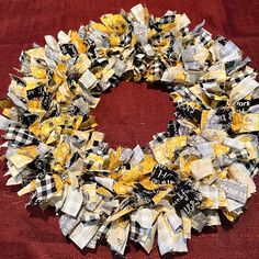 a yellow and black wreath on a red blanket