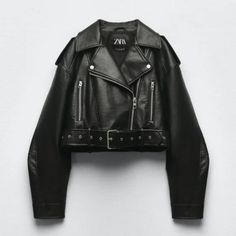 a black leather jacket with zippers on the sleeves and cuffs, sitting against a white wall