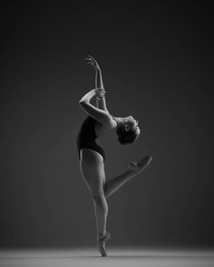 a woman in a black leotard doing a dance pose