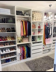 an organized closet with shoes, bags and handbags on the shelves in front of chandelier