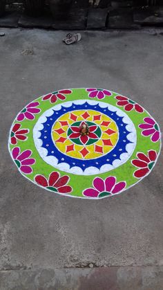 a colorful flower design on the ground