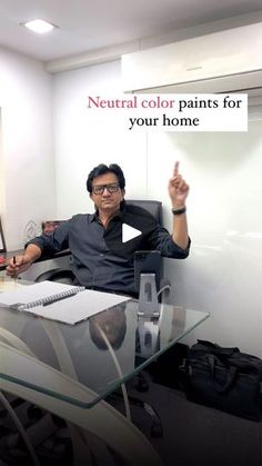 a man sitting at a desk in front of a laptop computer with the words neutral color paints for your home