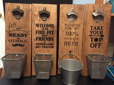 three wooden signs that say welcome to the fire department and have metal buckets on them