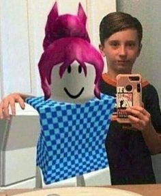 a young boy taking a selfie in front of a doll