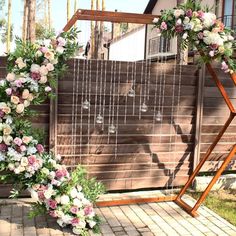 a wedding arch with flowers and greenery on it