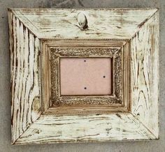 an old wooden frame with a hole in the center on concrete flooring, closeup