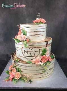 a three tiered cake decorated with flowers and leaves