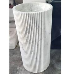 a large white vase sitting on top of a table