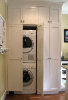 a washer and dryer are in the closet next to each other on the floor