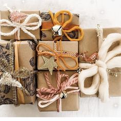 presents wrapped in brown paper with bows and decorations on them, all tied up together