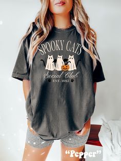 Be on trend this Halloween with this cute and unique Spooky Ghost Cats Social Club Shirt! This Halloween Comfort Colors® Tshirt is sure to be a hit at the Halloween Party or to surprise the Trick or Treaters! Super comfy! Size up for a Trendy Oversized Look! SHIPS FREE! SIZING TIPS: Size up 2-3 sizes from your "usual size" to get the "Oversized" Look! (2 sizes up is most common, and 3 sizes up is more dramatic) For a "relaxed fit" order your "usual size". When in doubt, lay your favorite fitting Spooky Halloween Cat Design Top, Spooky Halloween T-shirt With Graphic Print, Spooky Halloween Graphic T-shirt, Halloween Graphic Tee With Cat Design, Halloween Cat Design Graphic Tee, Halloween Social, Halloween Cat Print Graphic Tee, Spooky Cat Design T-shirt For Fall, Spooky Halloween T-shirt With Cat Design