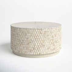 a round table made out of woven material on a white background with no people around it