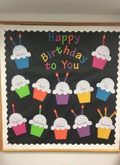 a birthday bulletin board with cupcakes on it