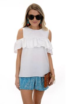 A cute cold shoulder top with a ruffled sleeve detail in a classic white hue! Top has a button keyhole detail in the back. So cute with our &quot;Turquoise Palms Short.&quot; Fabric is a crisp cotton-blend.     Fit is true to size. Mattie is wearing size small. White Ruffled Off-shoulder Top For Day Out, White Off-shoulder Top With Ruffles For Day Out, Chic Cold Shoulder Tops For Day Out, Casual Cold Shoulder Tops For Brunch, White Ruffle Sleeve Tops For Vacation, Summer Cotton Tops With Ruffle Sleeves, Casual White Cold Shoulder Top, Summer Ruffle Sleeve Tops For Vacation, Chic Ruffle Sleeve Beach Tops