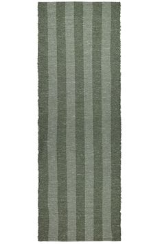 a green rug with vertical stripes on it