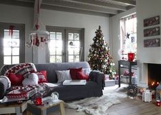 a living room filled with furniture and a christmas tree