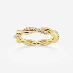 a yellow gold ring with diamonds on the sides and an intertwined design in the middle