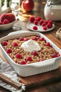 a bowl of granola with yogurt and raspberries on the side