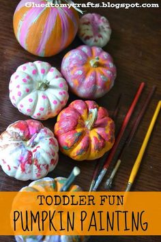 toddler fun pumpkin painting project for fall with oranges and white painted pumpkins