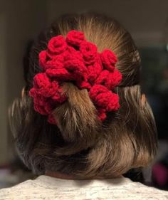 a woman wearing a red knitted hair clip