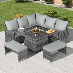 an outdoor dining set with grey cushions