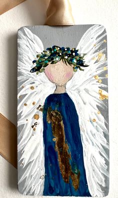 an angel painted on a piece of wood