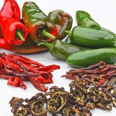 peppers and other vegetables on a white surface